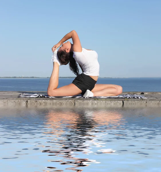 Mujer joven practicando ejercicio de yoga — Foto de Stock