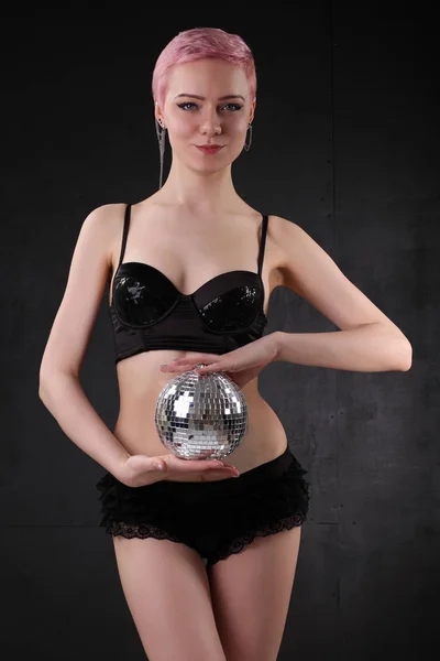 Young girl in black lingerie with a disco ball — Stock Photo, Image