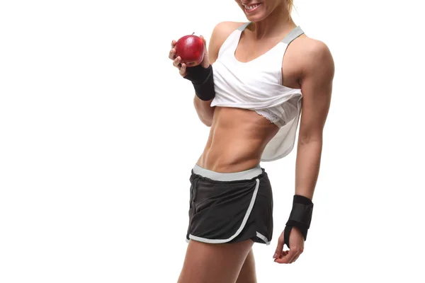 Donna muscolosa snella in possesso di mela rossa — Foto Stock