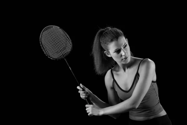 Jong meisje met een raket speelt badminton — Stockfoto