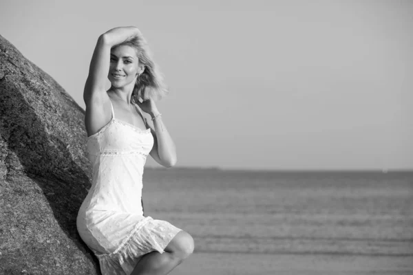 Happy woman on the beach at sunset Stock Photo