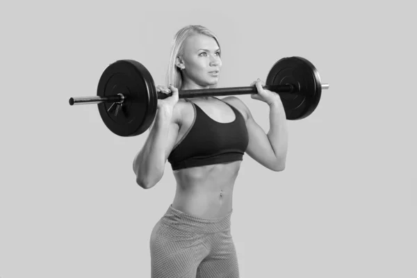 Young strong girl raises the barbell — Stock Photo, Image