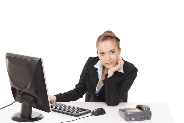 Young girl sitting at a table in the office — Stock Photo, Image