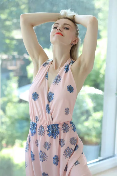 Blondýnka mladá žena v květinové letní šaty — Stock fotografie