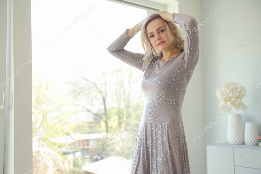 Beautiful young blonde woman in long dress