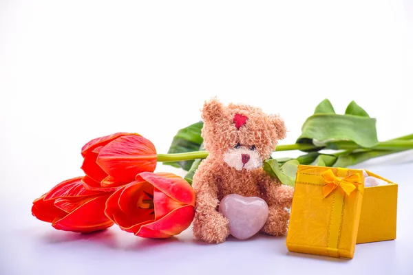 cute brown teddy bear, bouquet of red tulips, gift box, festive backdrop for birthday, Valentine\'s day, anniversary, close up