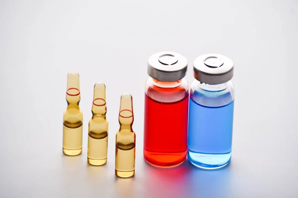 Medical vials and ampoules for injection. medicines and disease treatment. Blue and red vials and ampoules. pharmacology and science. Copy space.