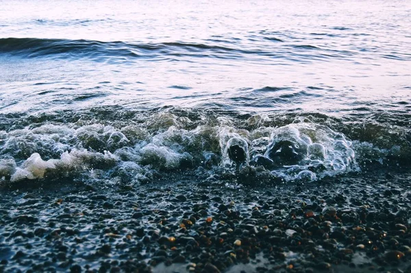 波や泡が海岸にぶつかっています 選択的焦点 ロイヤリティフリーのストック写真