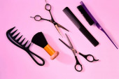 Hairdressing various accessories on a pink background. concept of the hairdressing beauty industry