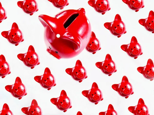 concept of saving money in a red piggy Bank. pattern of red piggy banks on a light background.