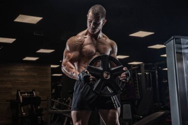 Bir adam pazı, halter ile eğitim salonunda, trenler.