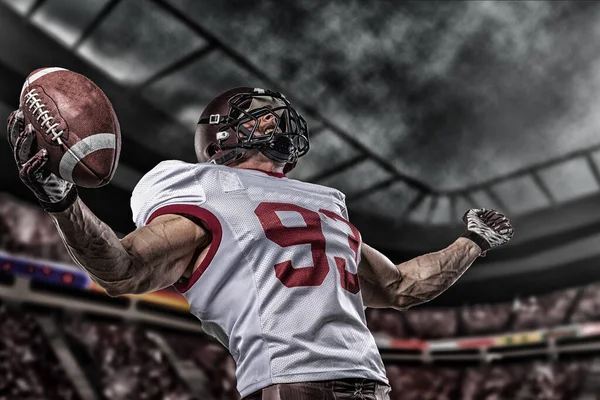 American football sportsman player on stadium with lights on background