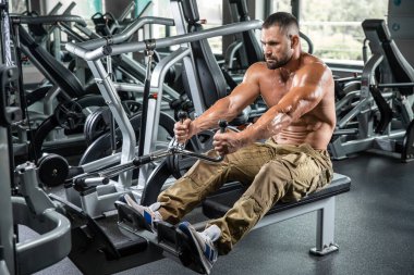 Çekici uzun kaslı vücut geliştirici. Moder fitness merkezinde ağırlık kaldırıyor..