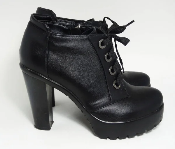 Black heeled ankle boots on a white background. Women\'s shoes for autumn or spring.