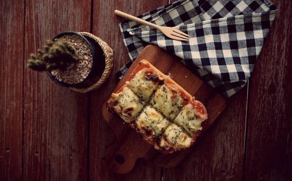 Pizza toasted bread with tomato sauce and ham cheese selective focus, picture vintage style