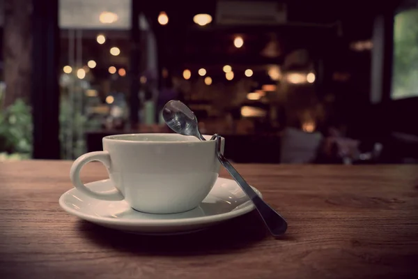 Coffee cup in coffee on table in cafe, vintage style Stock Image