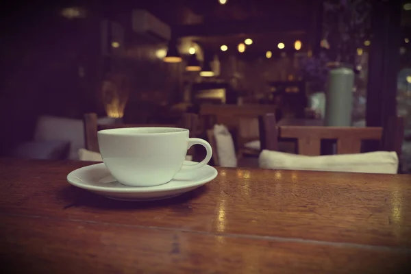 Coffee cup in coffee on table in cafe Royalty Free Stock Images