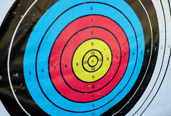 Archery target close up with many arrow holes