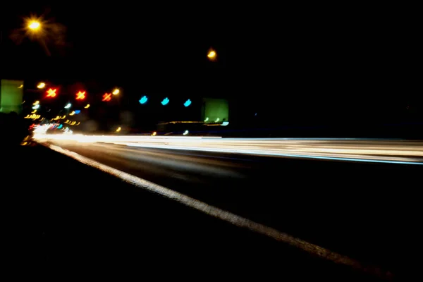 Iluminación borrosa y luces nocturnas, desenfoque del movimiento del tráfico del coche —  Fotos de Stock