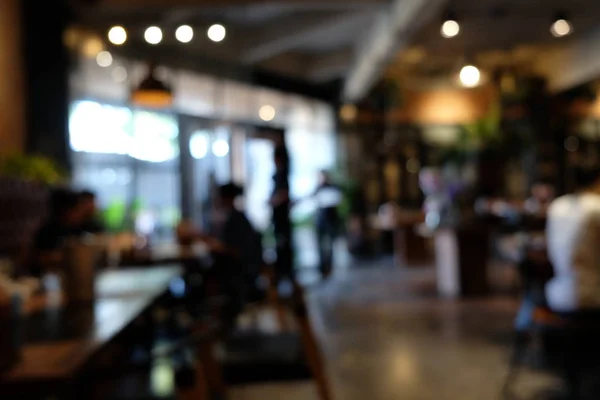 Coffee shop blur background with bokeh light with vintage filter