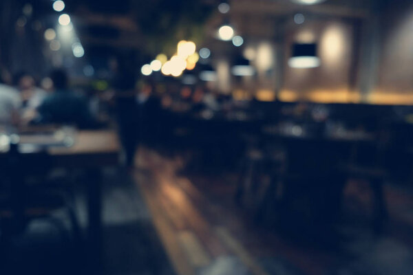 Coffee shop blur background with bokeh light with vintage filter
