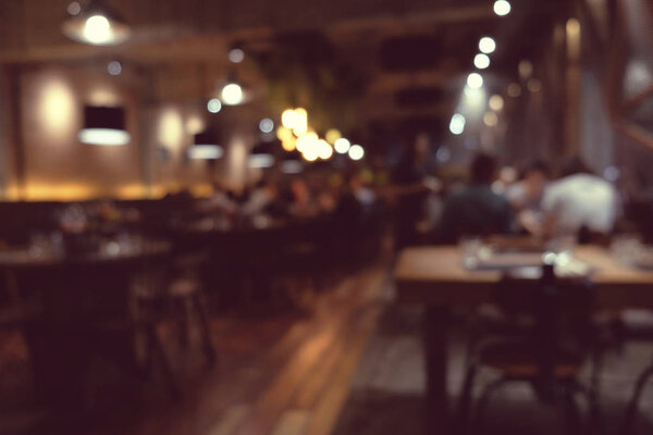 Coffee shop blur background with bokeh light with vintage filter