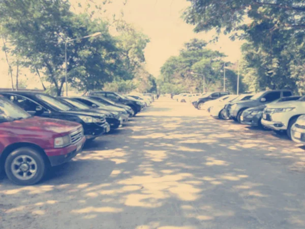 Blured image of cars in parking lot on day time — Stock Photo, Image
