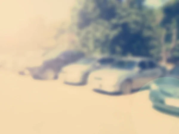 Blured image of cars in parking lot on day time — Stock Photo, Image