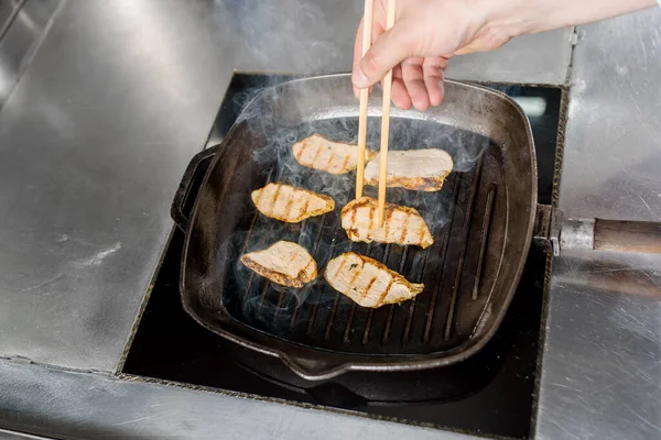 Fried pork cut with a knife. Big peace of pork meat. Cutting meat. Chef cut pork with knife. Advert for meat menu for restaurant