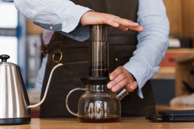 Uçak kahvesi yakın plan: kahve makinesi cihaza baskı yapıyor ve kahve damlaları tencereye uçakları dolduruyor. Alternatif İskandinav kahve demleme yöntemi.