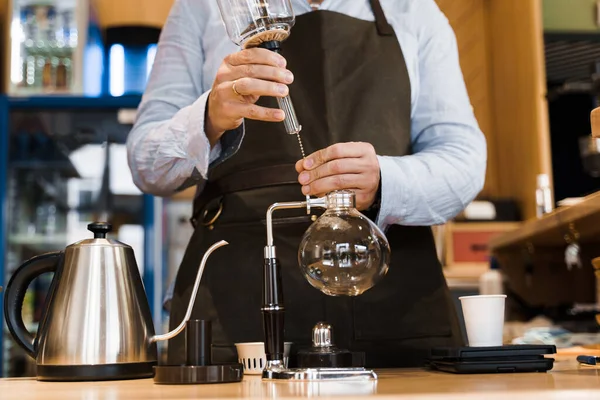 Syphon alternative method of making coffee. Barista prepare device for coffee brewing in cafe. Scandinavian method of coffee making.