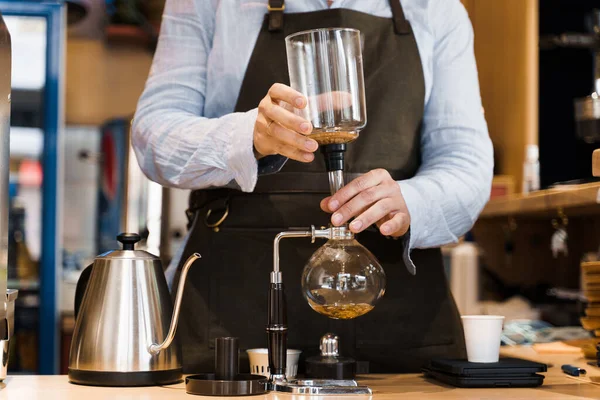 Syphon alternative method of making coffee. Barista prepare device for coffee brewing in cafe. Scandinavian method of coffee making.