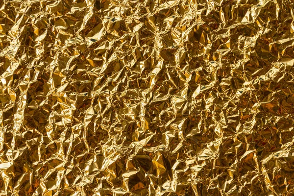 wrinkle shiny foil paper, golden sheet background, copy space