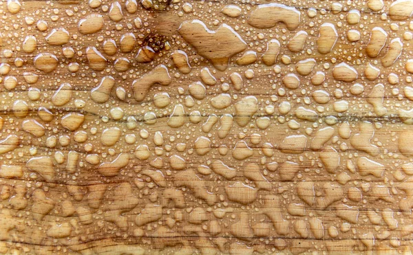 wet brown wooden surface background with water drops