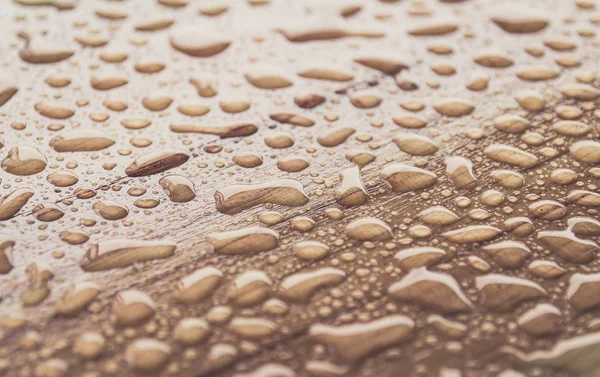 wet brown wooden surface background with water drops