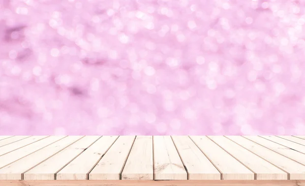 Wood table or wood floor with abstract pink bokeh background for product display