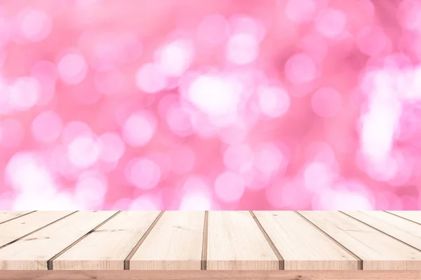 Wood table or wood floor with abstract pink bokeh background for product display