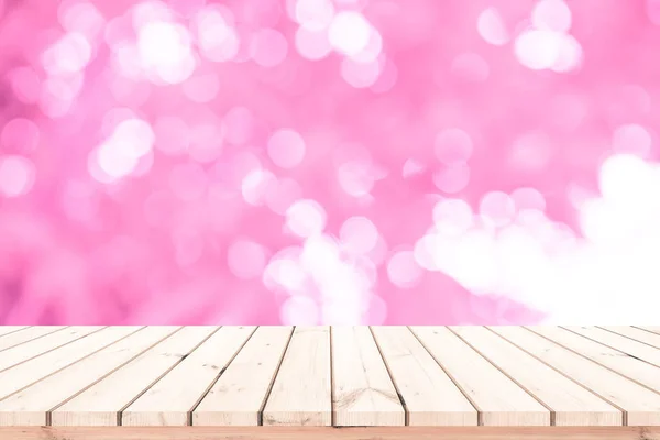 Wood table or wood floor with abstract pink bokeh background for product display