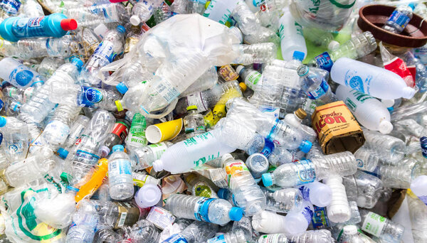 heap of old dirty plastic bottles in garbage