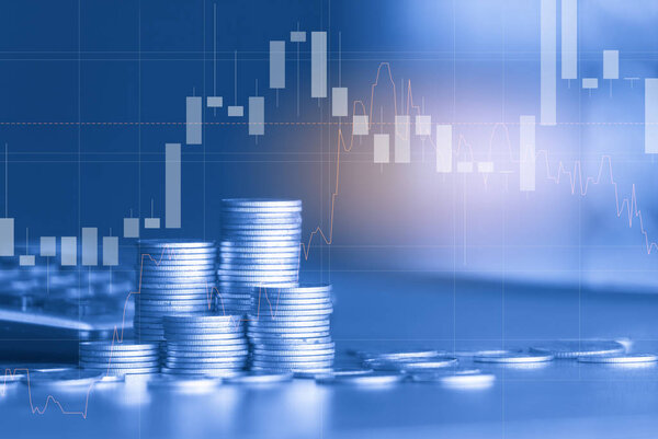Stacks of golden coins with trading graph on background , financial investment concept 