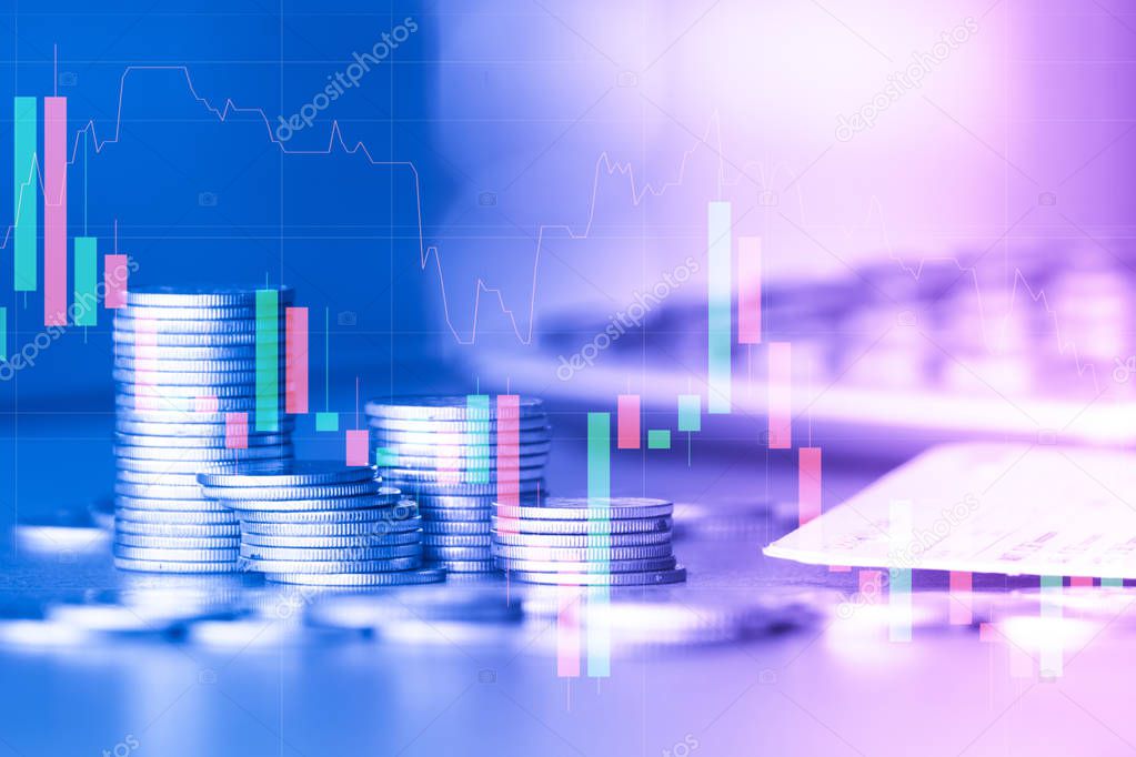 Stacks of golden coins with trading graph on background , financial investment concept 