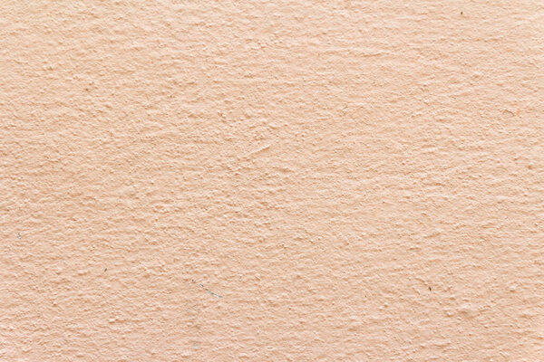Textured peach-colored wall surface