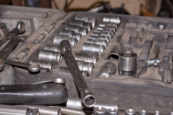 Set of round mechanic tools in the box. Car mechanic concept in the old mechanic workshop.