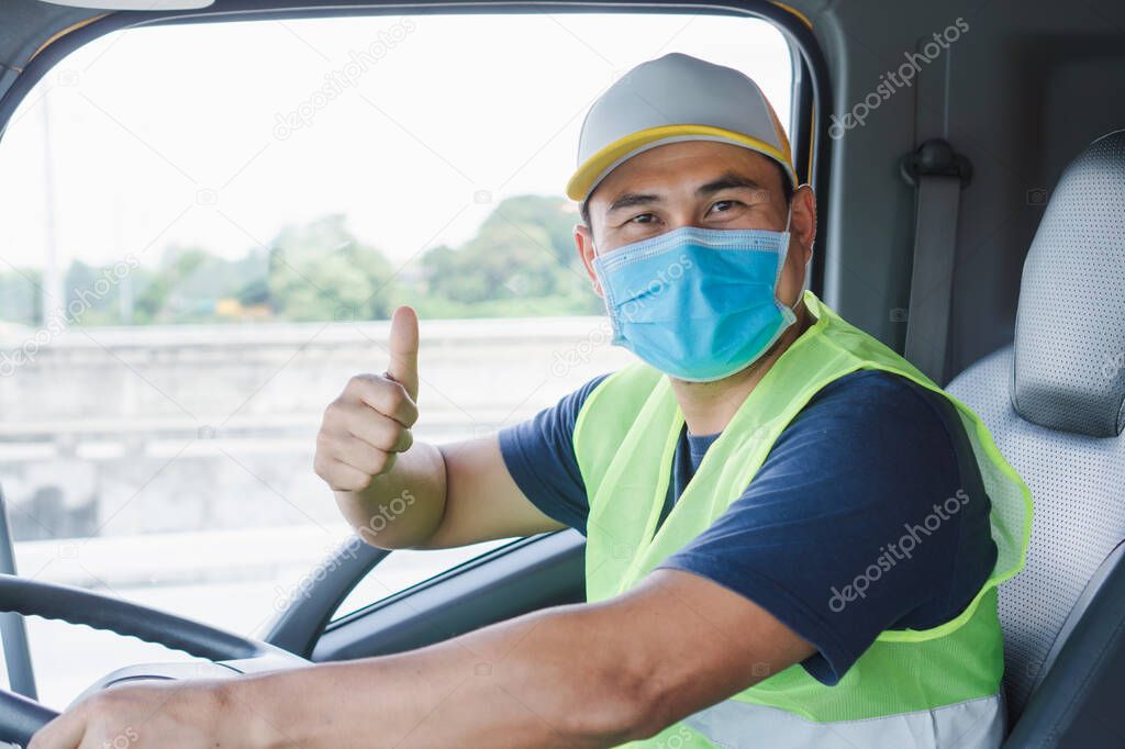 Professional worker, truck driver, middle-aged Asian man wearing protective mask And safety vests For a long transportation business