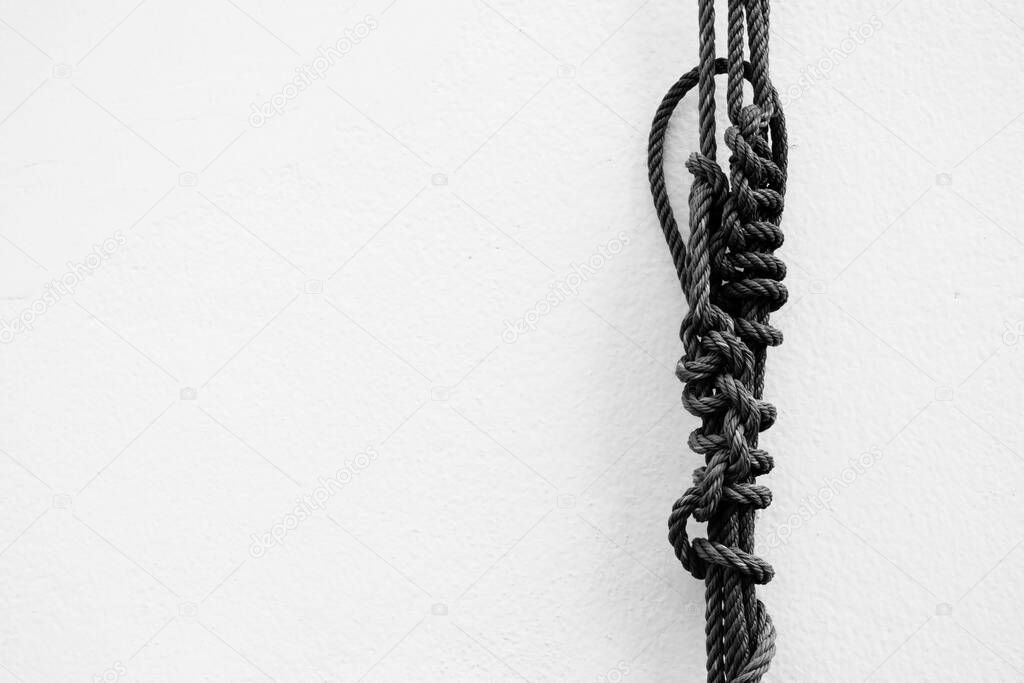 Rope with White Cool Concrete Wall Texture Background.