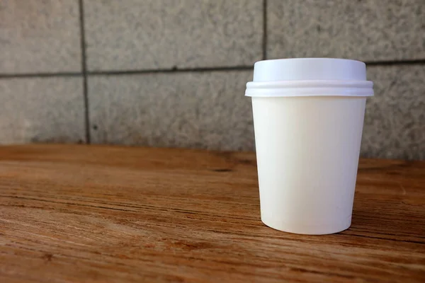 White Take-away Coffee Cup on Wooden Table.