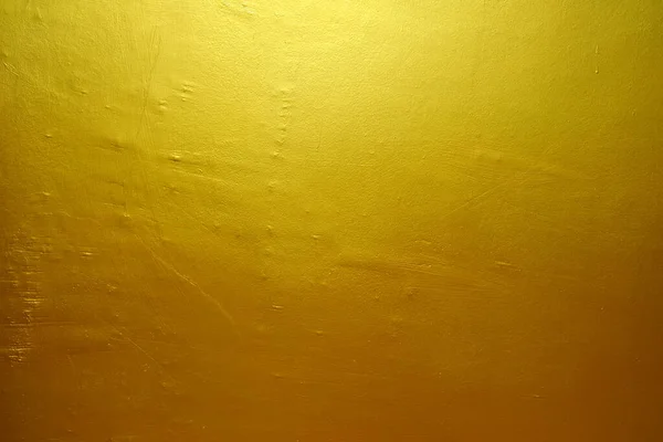コンクリート壁のテクスチャ上のゴールドペイント背景 — ストック写真