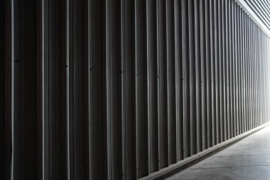 Koridordan sızan ışıkla birlikte oyulmuş metal duvar..