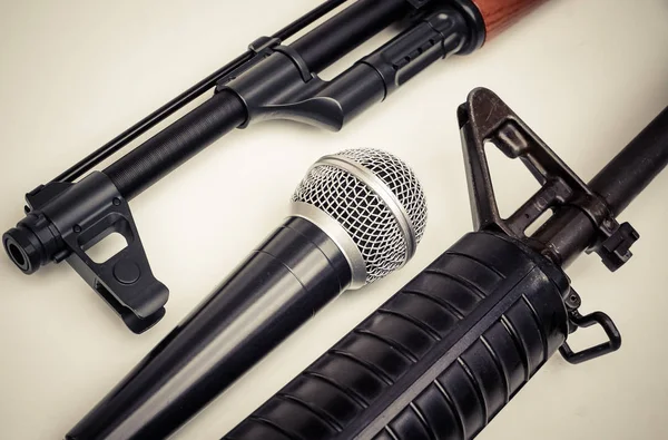 Microphone vs. Rifle / Freedom of the press is at risk concept / World press freedom day concept