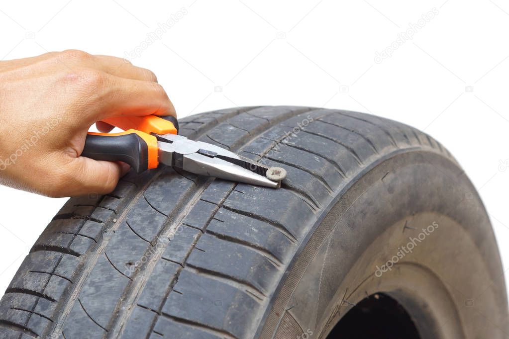 Removing a bolt from a flat tire using pliers